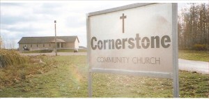 Gray brick church with church sign in front