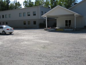 Car port at the entrance of the gray and white new building
