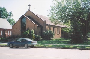 Red brick church with cross on top
