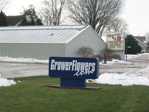 Sign in front of Grower Flowers greenhouse in winter