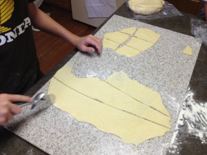 Dough is rolled thin and cut into squares for frying
