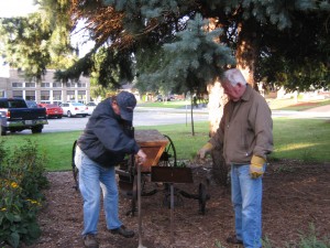 Cementing the sign for the plough, which was donated earlier this year.