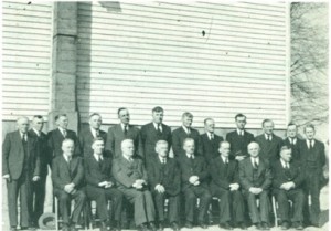 Ontario Ministers' and Deacons' Conference at Leamington, March 17,  1945. Seated from left to right: Wilhelm Schellenberg, J. J. Wichert, Vine-  land, Jac. H. Janzen, Waterloo, P. H. Richert, U.S.A., N. N. Driedger,  J. A. Dyck, Niagara, P. H. Dirks, Niagara, Joh. Friesen, Glenlea. Standing:  H. B. Wiens, deacon, Joh. Reimer, Port Rowan, Jac. J. Epp, Nic. Schmidt.  Herm. P. Lepp, Nic. Fransen, Vineland, Gerh. Tiessen, Jac. N. Driedger.  C. K. Neufeld, Niagara, Abram Rempel, Jac. D. Janzen, Jac. Barkowsky,  Sr .. deacon.  