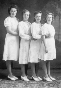 Portrait of four young women in white dresses