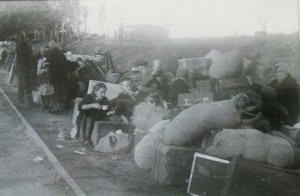 10-year-old Irene Dyck and family wait for a train with all the belongings they could carry.